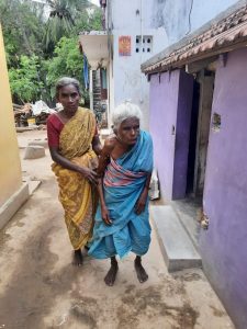 Periyakka's daughter helping Periyakka.