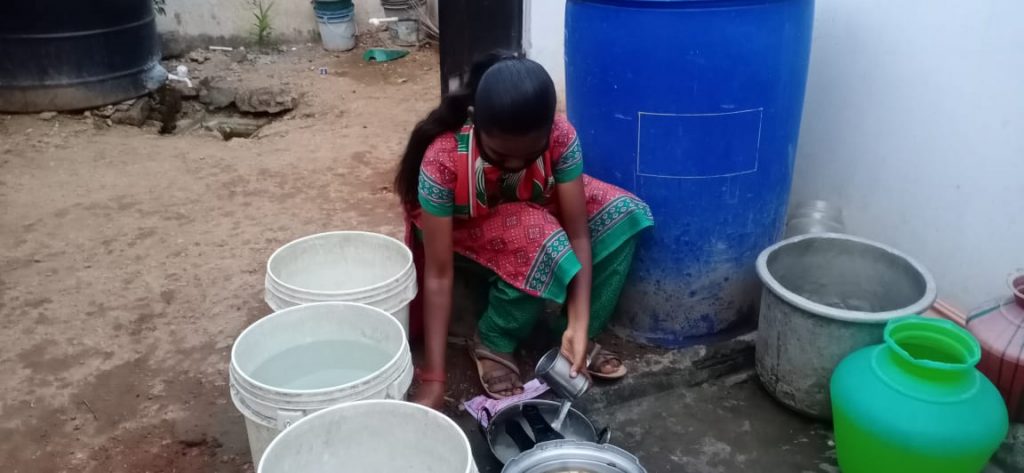 Hope Student Yazhini cleaning pots at her home.